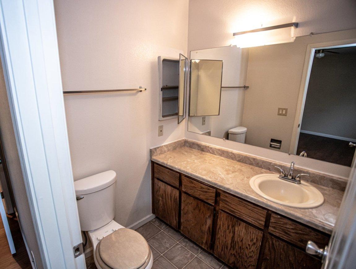 839 Springer Drive Redding, CA 96003 - Photo 5 of 10 a bathroom with a granite countertop sink toilet and shower