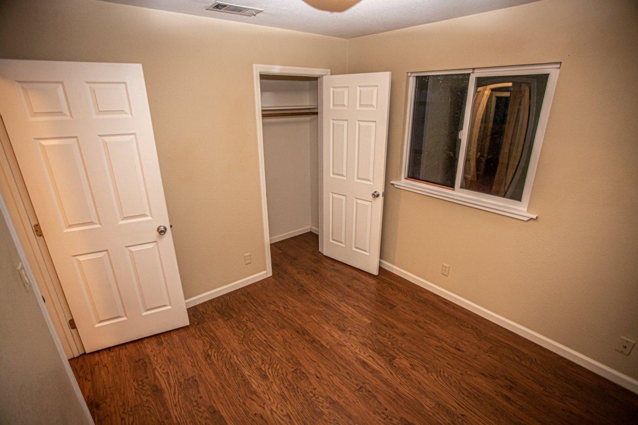 839 Springer Drive Redding, CA 96003 - Photo 6 of 10 an empty room with wooden floor and closet