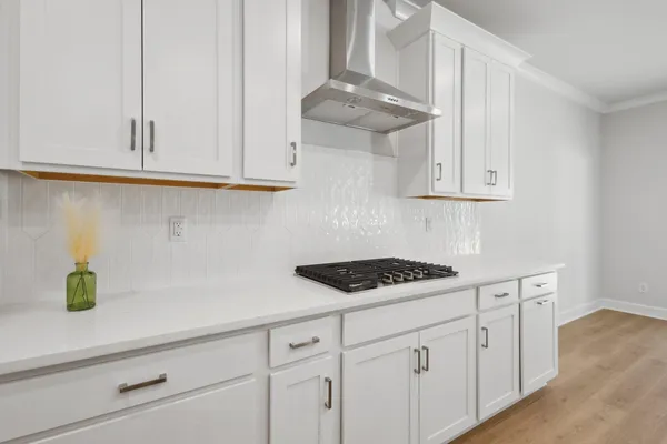 a kitchen with white cabinets and a sink