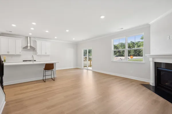 a view of kitchen with kitchen island wooden floor wooden floor and center island