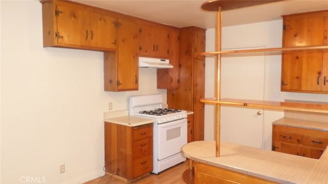 a kitchen with a stove and a refrigerator