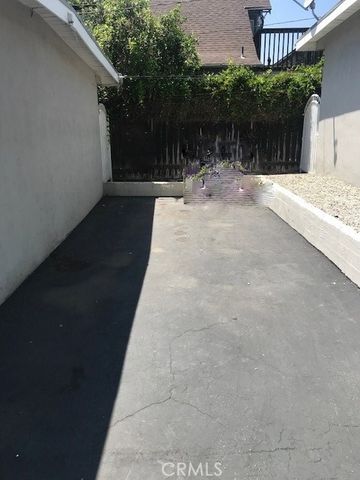 a backyard of a house with plants and trees