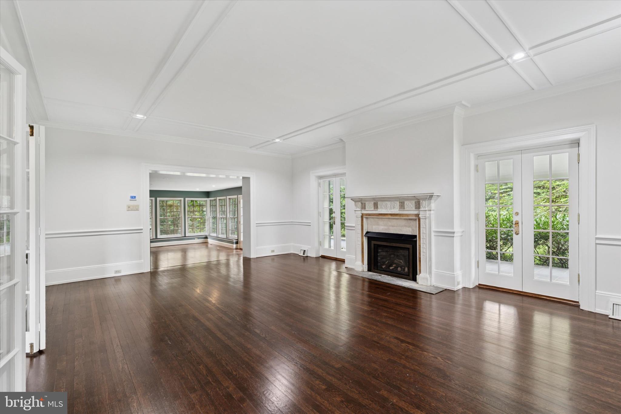 217 Glenn Road Ardmore, PA 19003 - Photo 12 of 65 a view of an empty room with wooden floor fireplace and a window