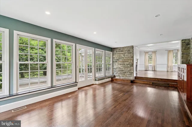 a view of a livingroom with lounge chair and a large window
