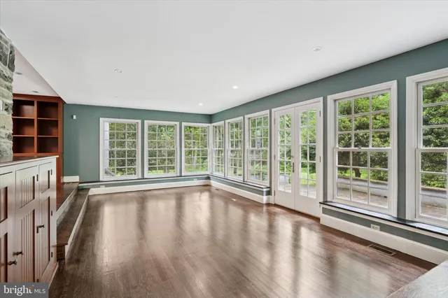 a kitchen that has a stove and a wooden floor