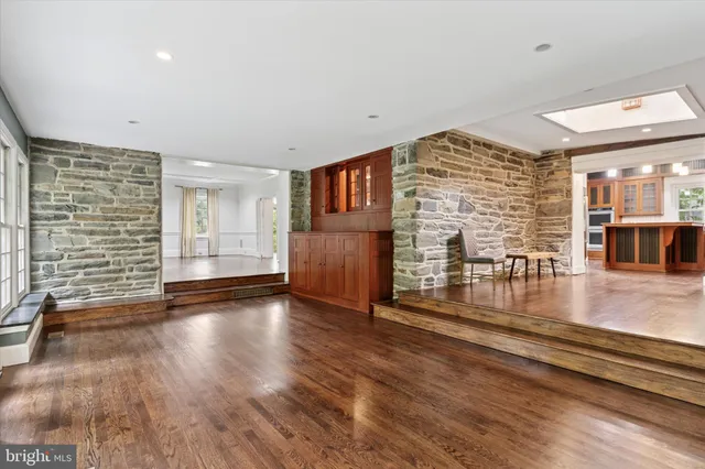 a view of a kitchen with stainless steel appliances granite countertop a refrigerator and a stove top oven