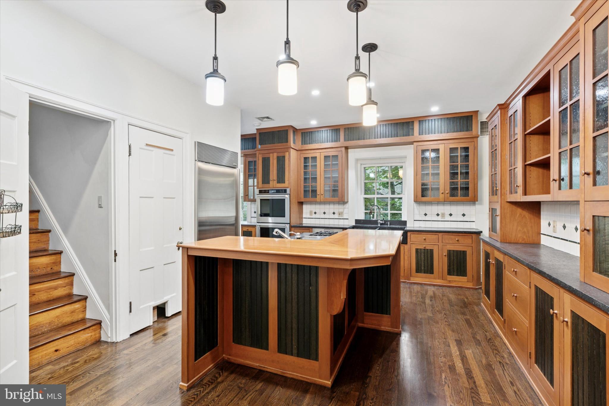 217 Glenn Road Ardmore, PA 19003 - Photo 25 of 65 a view of a kitchen with stainless steel appliances granite countertop a sink and wooden floors