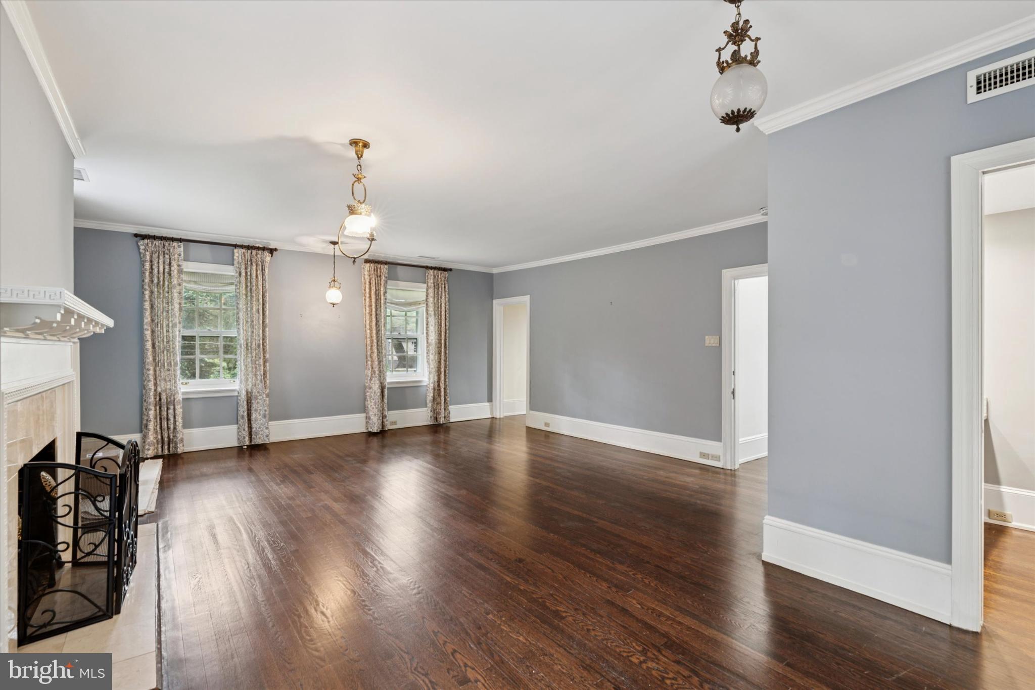 217 Glenn Road Ardmore, PA 19003 - Photo 38 of 65 an empty room with wooden floor chandelier and windows