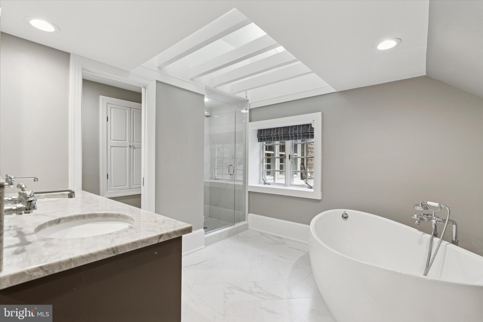 217 Glenn Road Ardmore, PA 19003 - Photo 43 of 65 a bathroom with a granite countertop tub sink and mirror