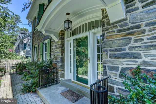 a view of a hallway with wooden floor and windows
