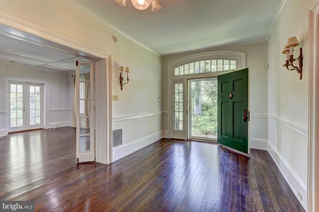 a view of an entryway with wooden floor and stairs