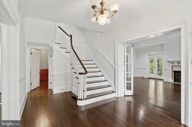 a view of an empty room with window and fire place