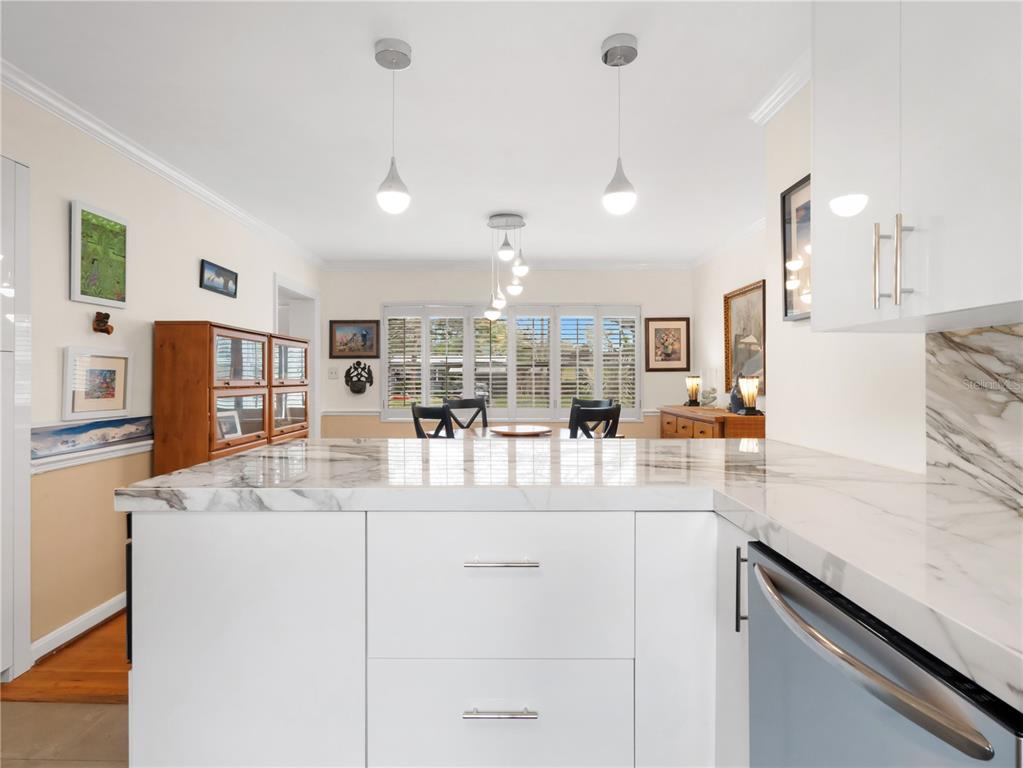 1632 Pinewood Drive Orlando, FL 32804 - Photo 13 of 28 a large kitchen with kitchen island a sink stainless steel appliances and cabinets