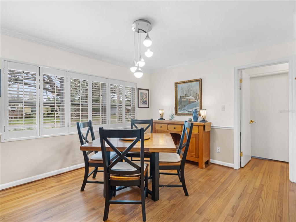 1632 Pinewood Drive Orlando, FL 32804 - Photo 15 of 28 a view of a dining room with furniture and wooden floor