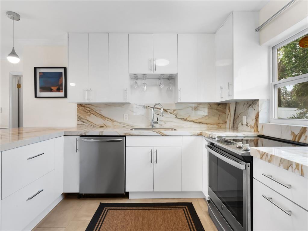 1632 Pinewood Drive Orlando, FL 32804 - Photo 10 of 28 a kitchen with granite countertop a sink stove and cabinets