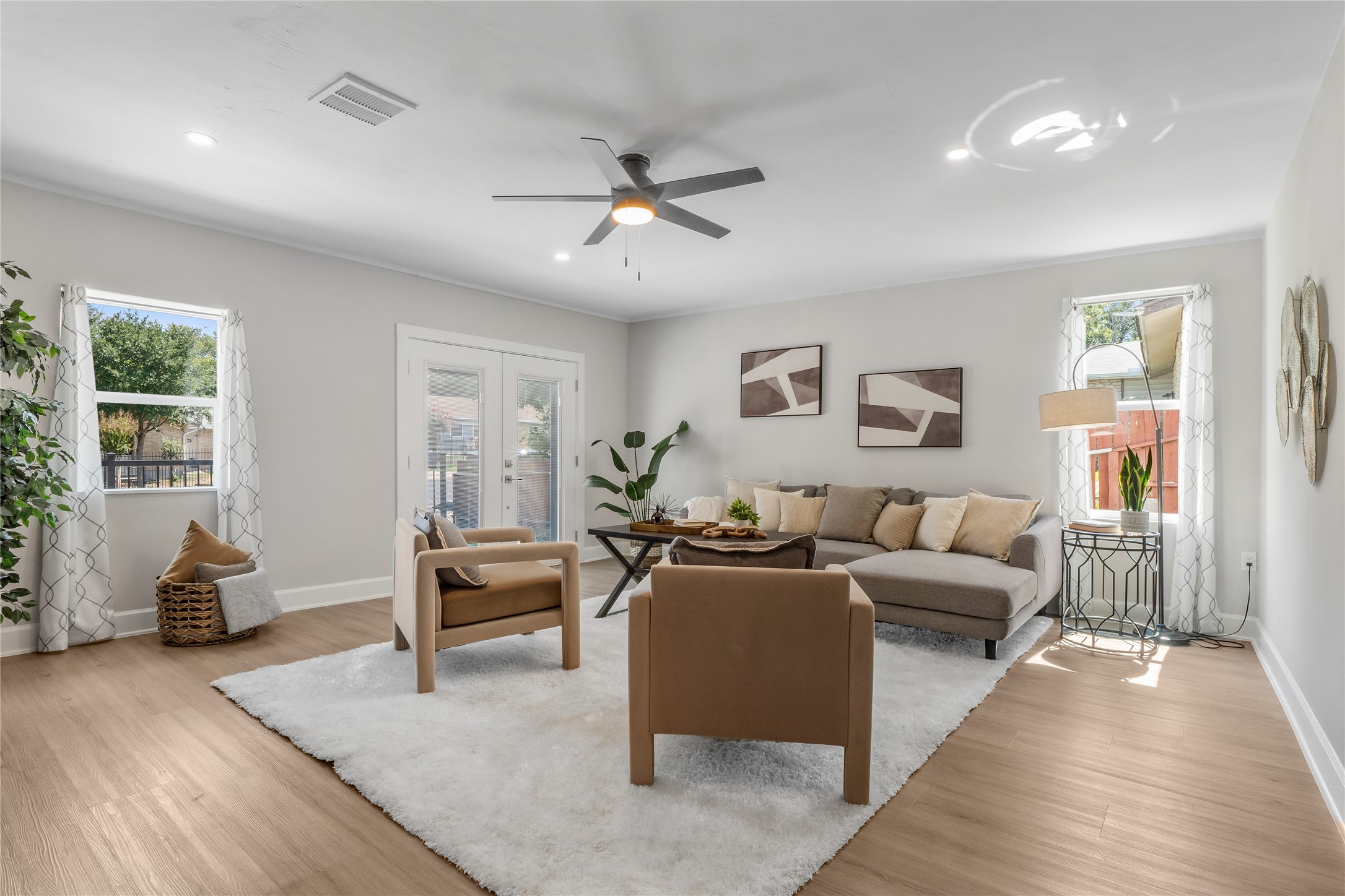8007 Colony Loop Drive Austin, TX 78724 - Photo 14 of 40 Expansive living room with modern ceiling fan, generous layout, and abundant natural light.