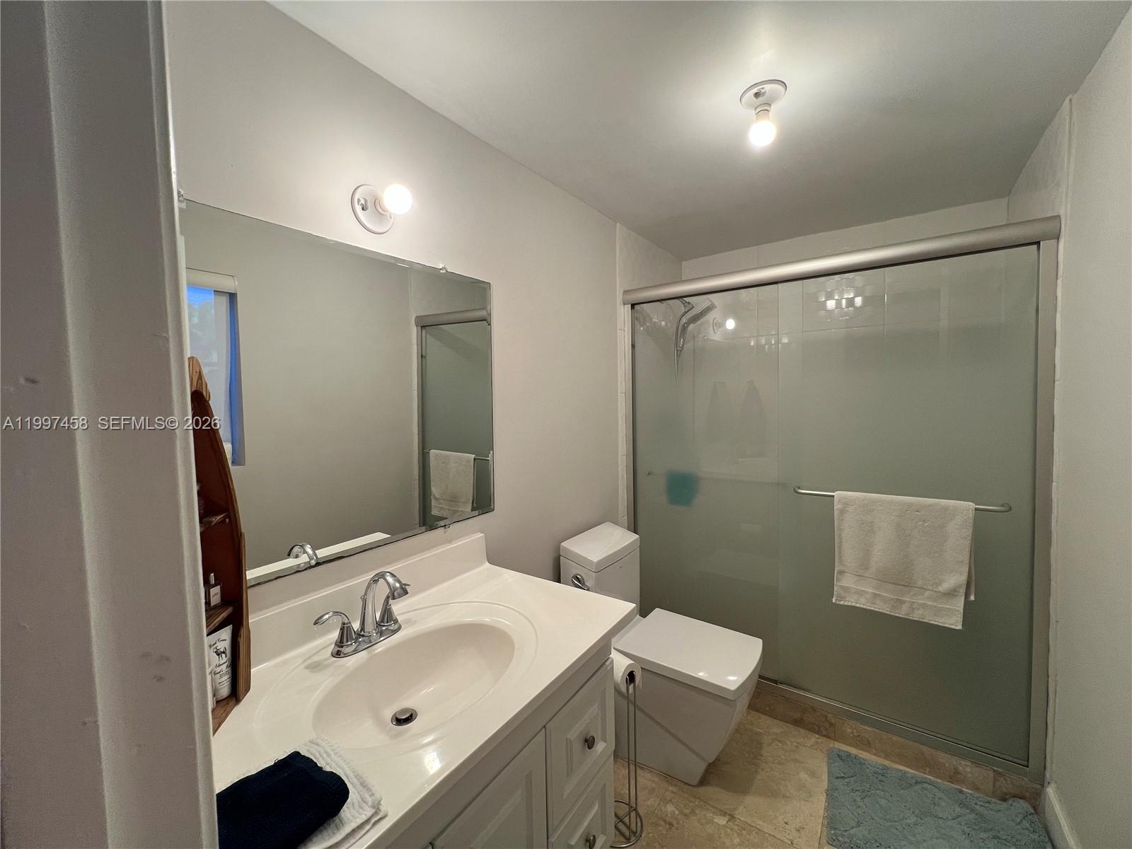 7405 Southwest 79th Court Miami, FL 33143 - Photo 11 of 29 a bathroom with a sink toilet and shower