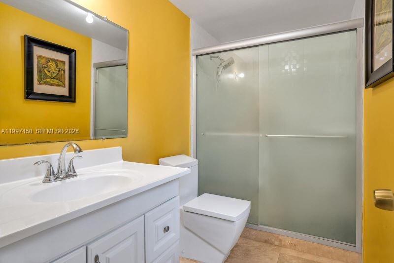 7405 Southwest 79th Court Miami, FL 33143 - Photo 12 of 29 a bathroom with a sink mirror vanity and toilet