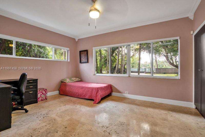 7405 Southwest 79th Court Miami, FL 33143 - Photo 17 of 29 a spacious bedroom with a bed and a window