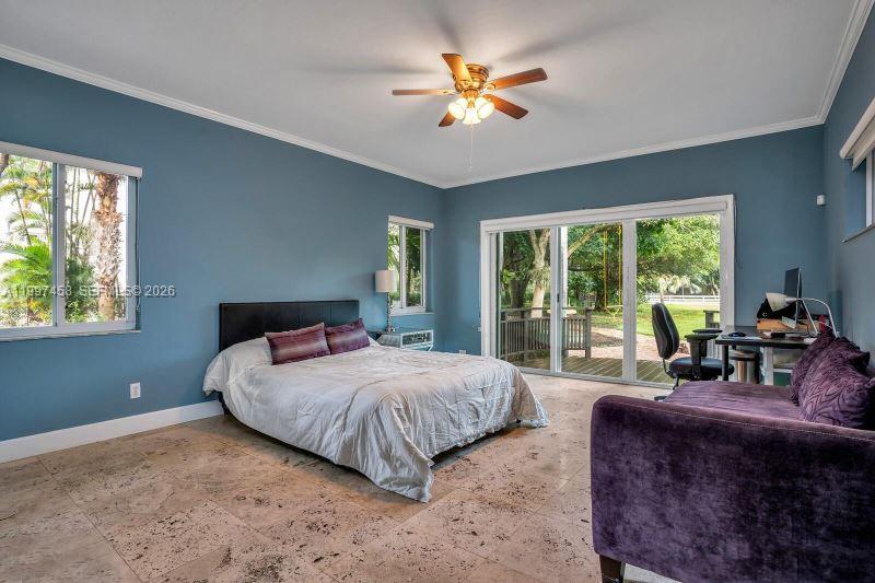 7405 Southwest 79th Court Miami, FL 33143 - Photo 18 of 29 a bedroom with a large bed and a chandelier