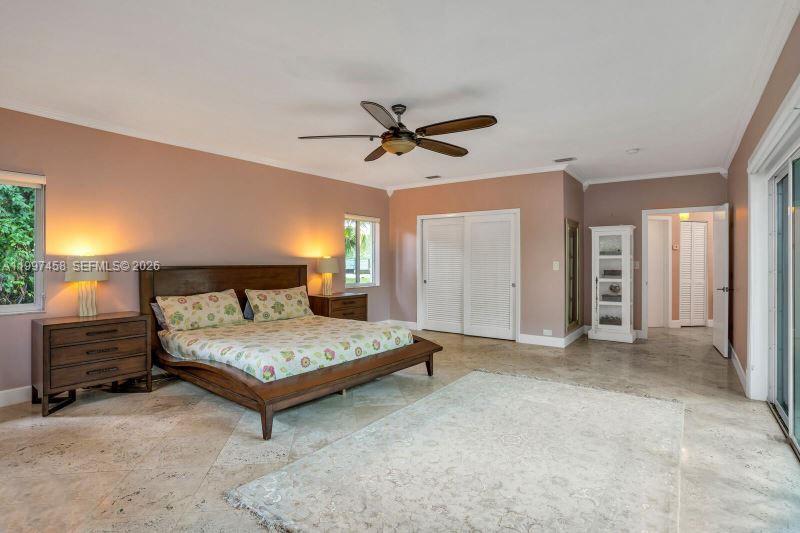 7405 Southwest 79th Court Miami, FL 33143 - Photo 21 of 29 a bedroom with a bed and a chandelier