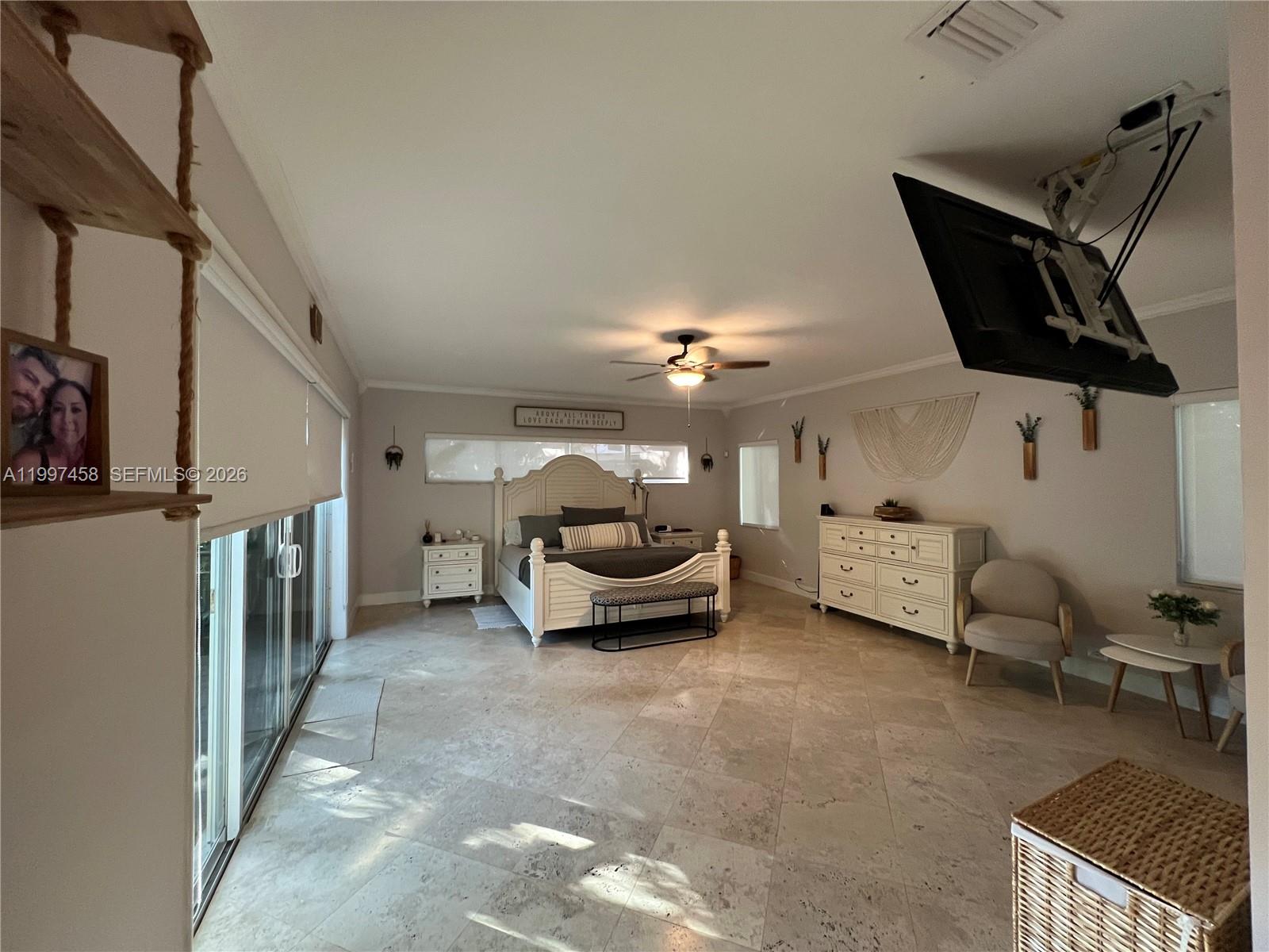 7405 Southwest 79th Court Miami, FL 33143 - Photo 22 of 29 a view of a livingroom with furniture and a ceiling fan