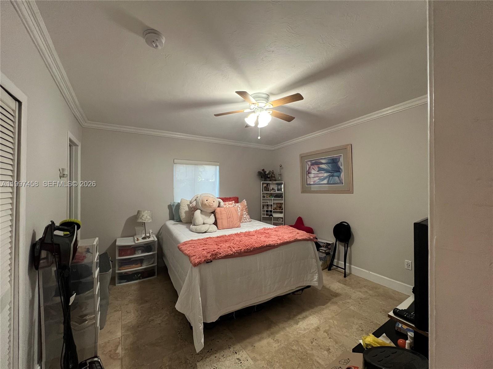 7405 Southwest 79th Court Miami, FL 33143 - Photo 28 of 29 a bedroom with a bed and a chandelier