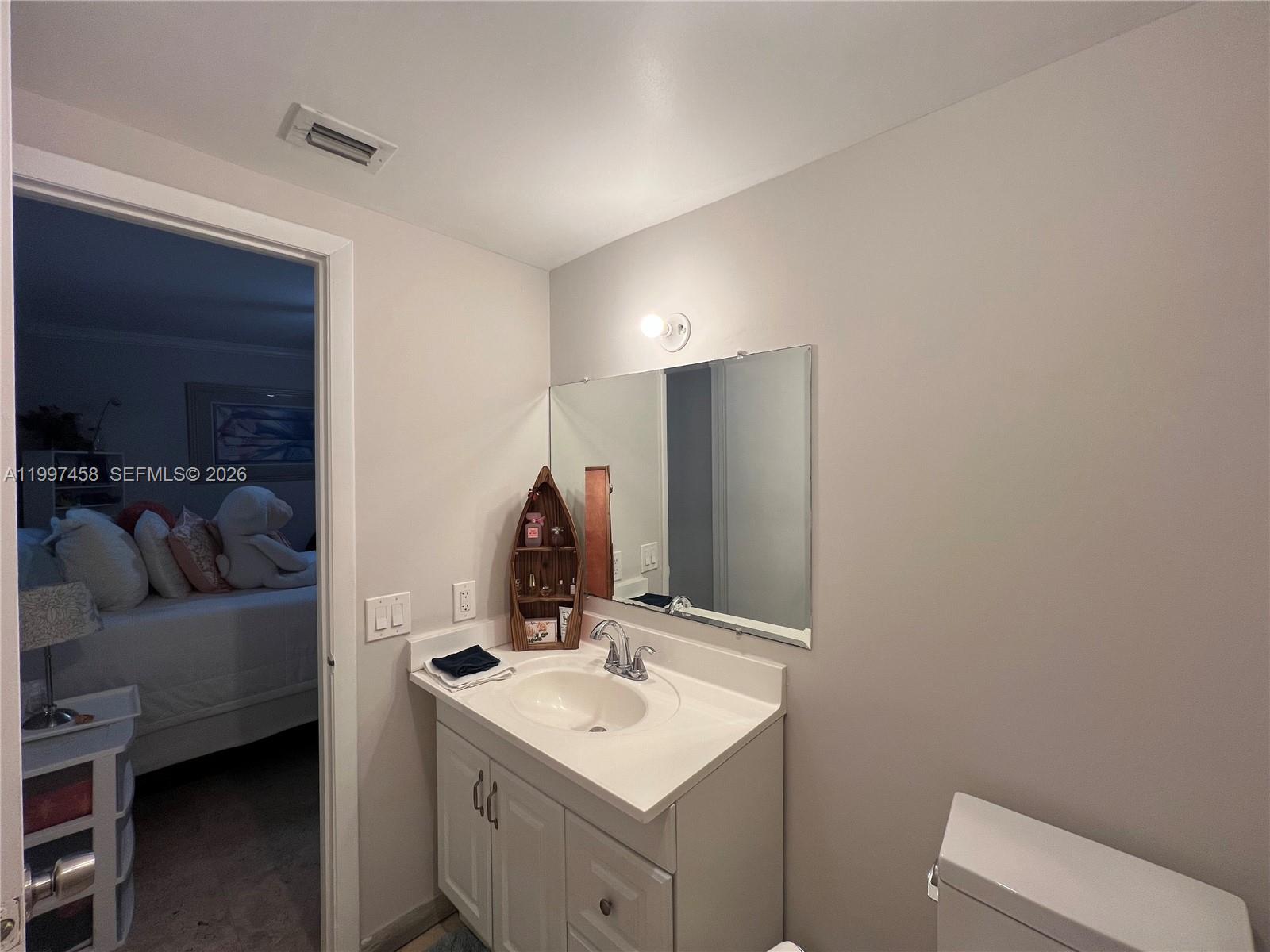 7405 Southwest 79th Court Miami, FL 33143 - Photo 29 of 29 a en suite bathroom with a toilet sink and mirror