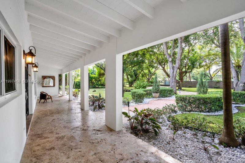 7405 Southwest 79th Court Miami, FL 33143 - Photo 3 of 29 a view of a porch with furniture and garden