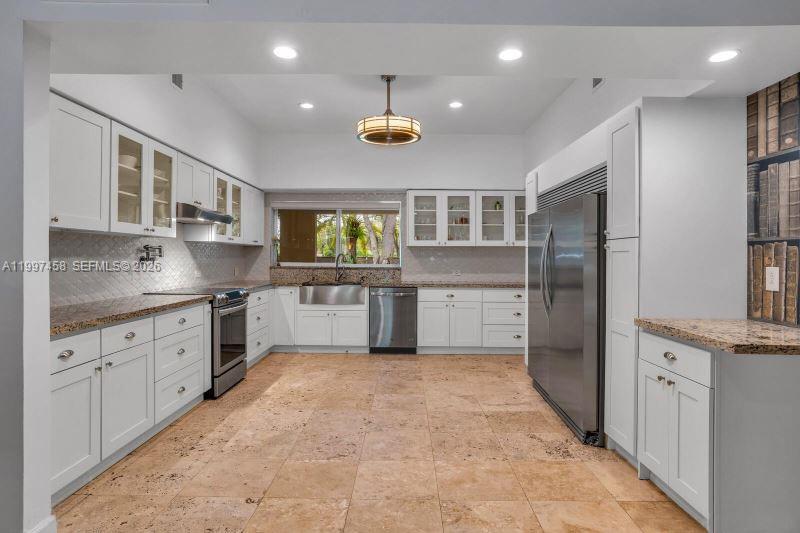 7405 Southwest 79th Court Miami, FL 33143 - Photo 5 of 29 a kitchen with stainless steel appliances granite countertop a refrigerator and a sink