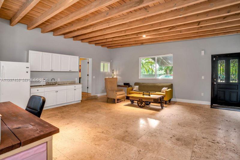 7405 Southwest 79th Court Miami, FL 33143 - Photo 6 of 29 a living room with furniture and a chandelier