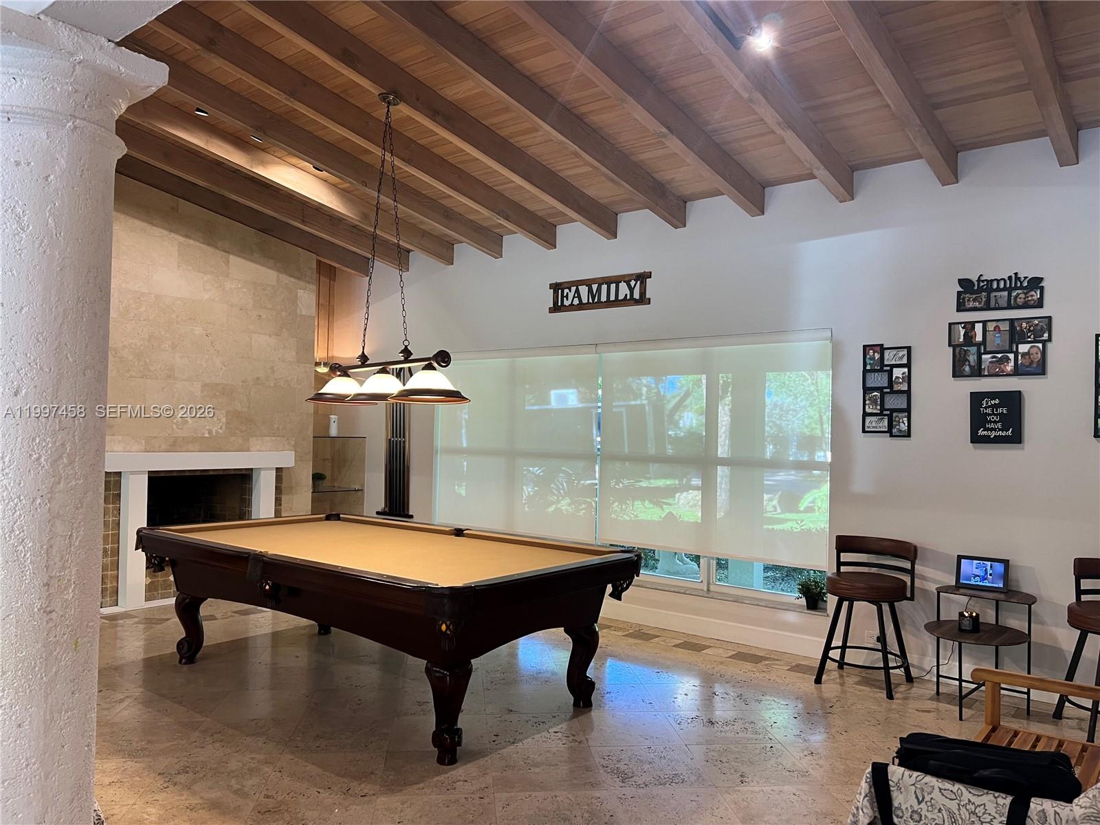 7405 Southwest 79th Court Miami, FL 33143 - Photo 8 of 29 a living room with pool table furniture and a chandelier
