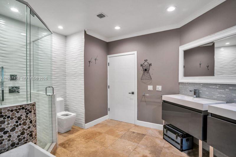 7405 Southwest 79th Court Miami, FL 33143 - Photo 9 of 29 a bathroom with a sink and a mirror