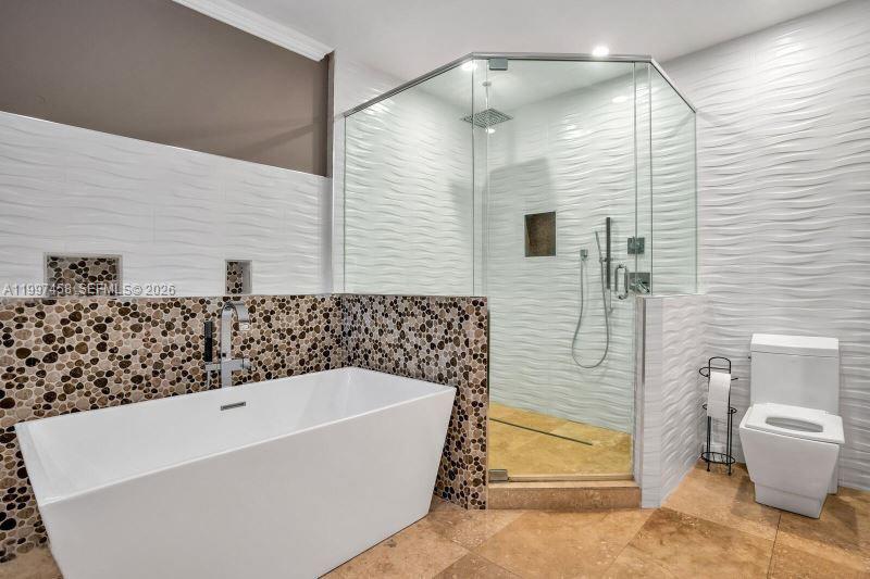 7405 Southwest 79th Court Miami, FL 33143 - Photo 10 of 29 a bathroom with a bathtub and shower