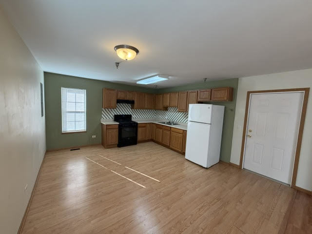 126 Washington Street, Unit A Ingleside, IL 60041 - Photo 4 of 9 a kitchen with stainless steel appliances a refrigerator and a stove