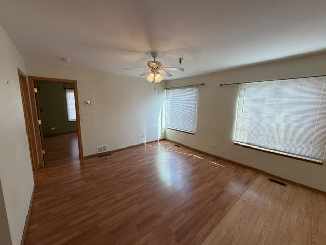 126 Washington Street, Unit A Ingleside, IL 60041 - Photo 6 of 9 wooden floor in an empty room with a window