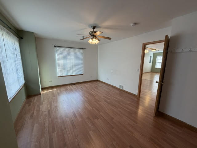 126 Washington Street, Unit A Ingleside, IL 60041 - Photo 7 of 9 a view of empty room with wooden floor and fan