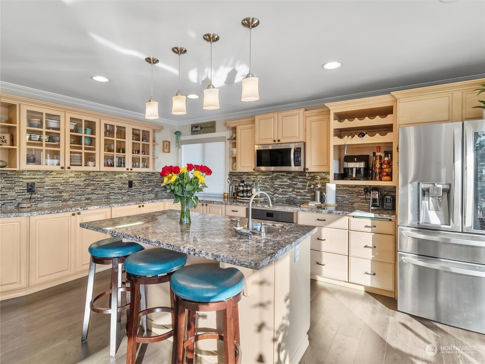 1304 153rd Street South Spanaway, WA 98387 - Photo 11 of 39 a kitchen with stainless steel appliances kitchen island granite countertop a stove and a refrigerator