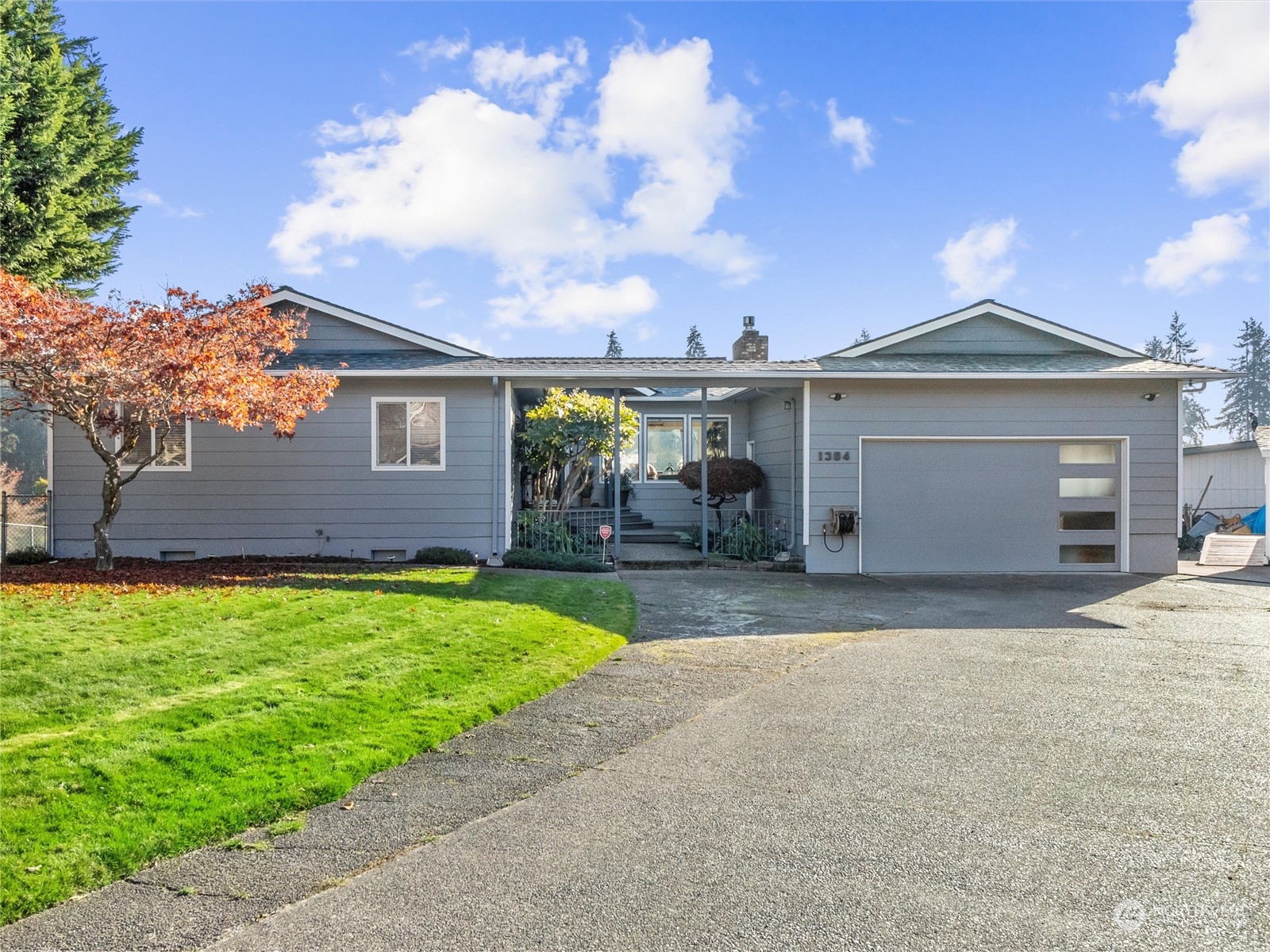 1304 153rd Street South Spanaway, WA 98387 - Photo 3 of 39 a front view of a house with garden