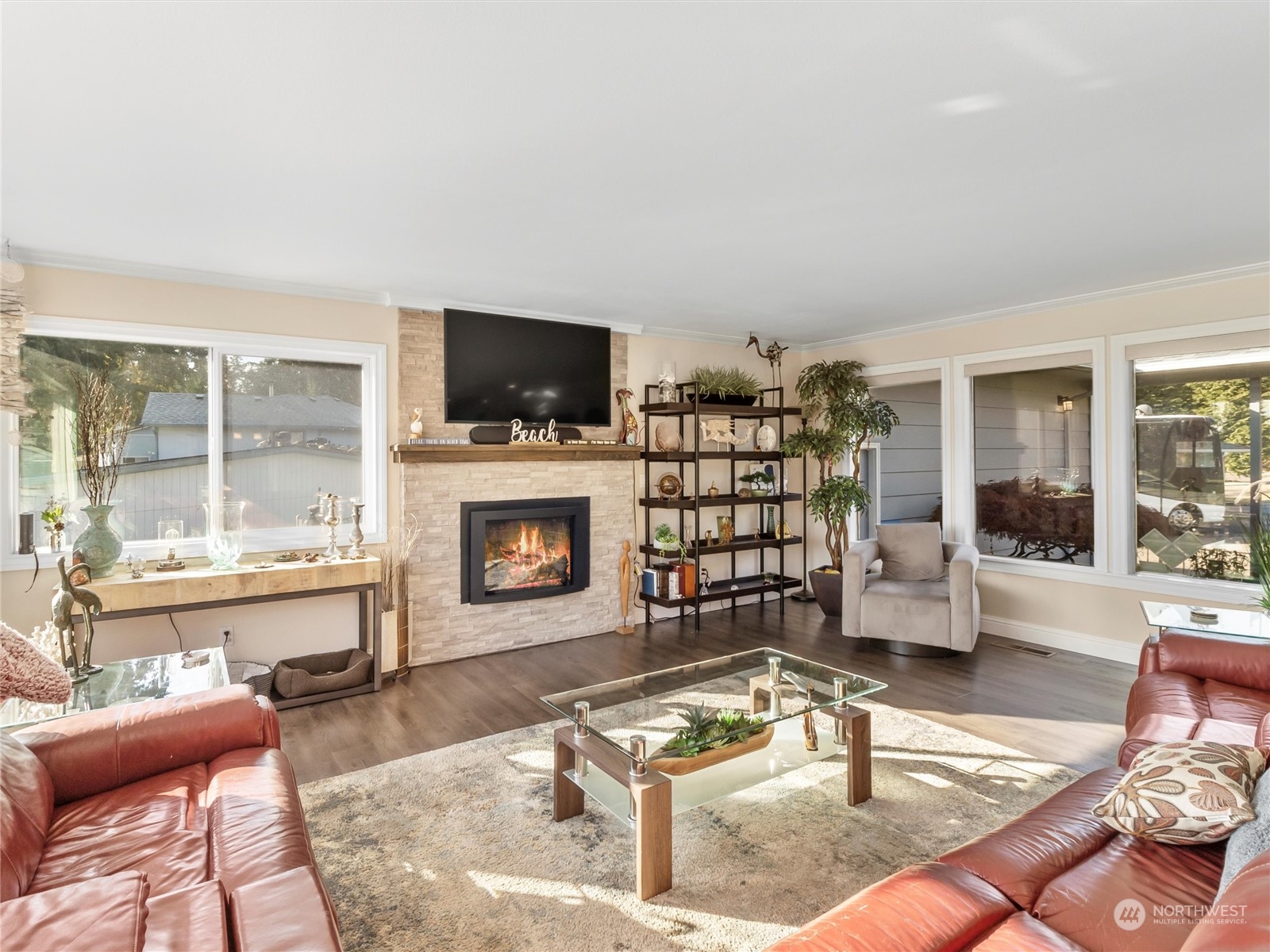 1304 153rd Street South Spanaway, WA 98387 - Photo 7 of 39 a living room with furniture a flat screen tv and a fireplace