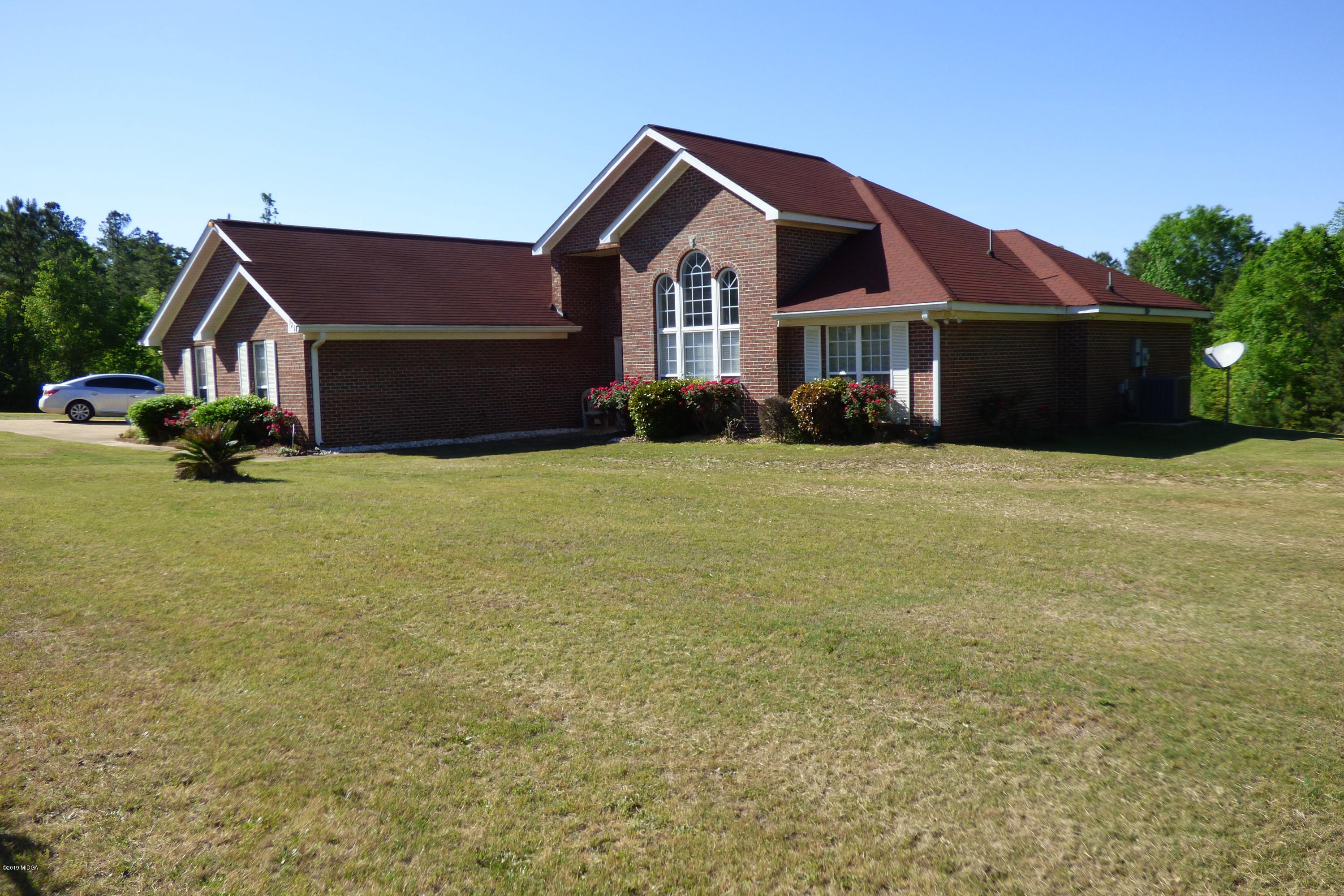 323 Rustin Road Reynolds, GA 31076 - Photo 2 of 25 a front view of a house with yard and garage