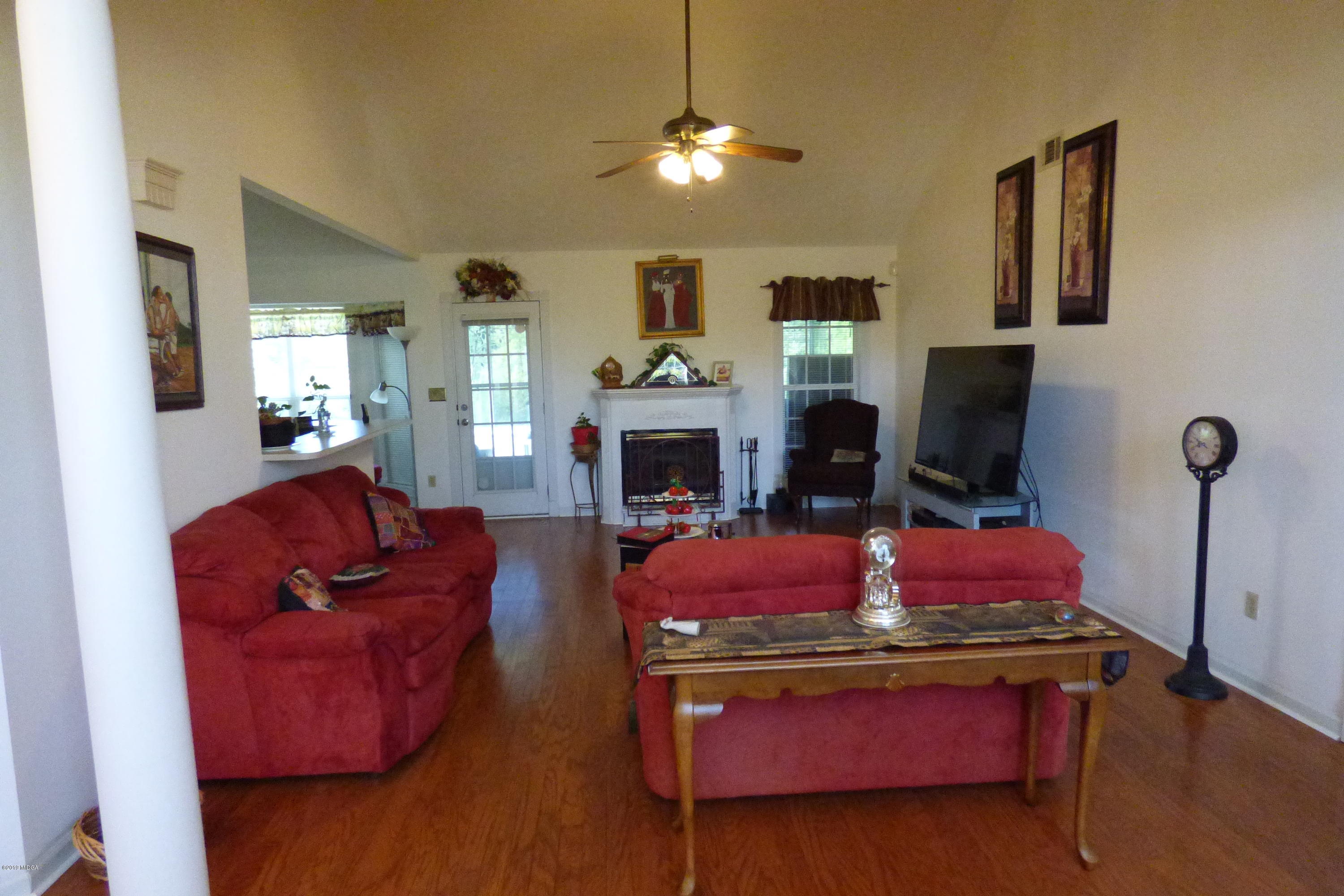 323 Rustin Road Reynolds, GA 31076 - Photo 11 of 25 a living room with furniture fireplace and flat screen tv