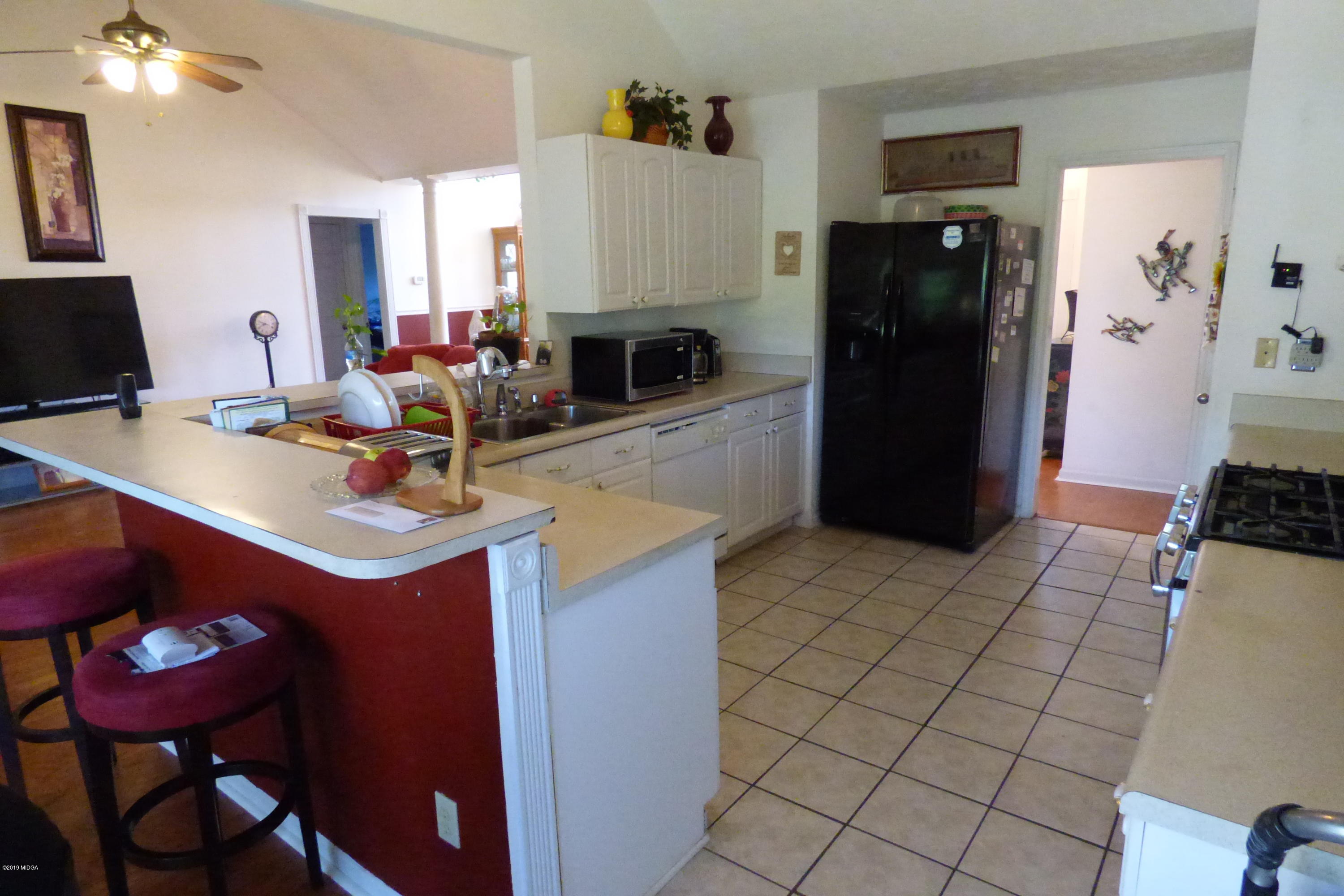 323 Rustin Road Reynolds, GA 31076 - Photo 15 of 25 a kitchen with a sink cabinets and appliances
