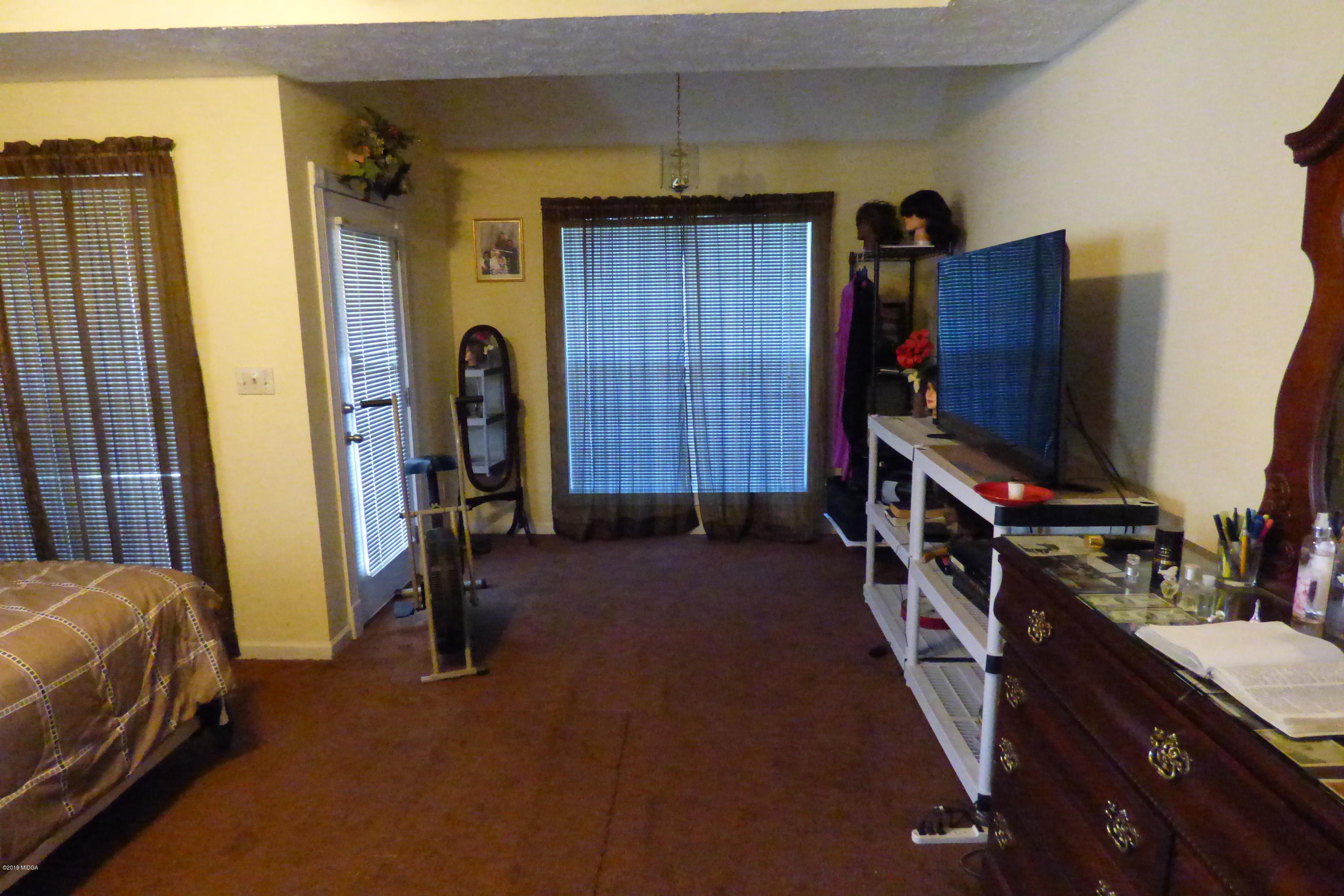 323 Rustin Road Reynolds, GA 31076 - Photo 20 of 25 a bedroom with a bed and a flat tv screen