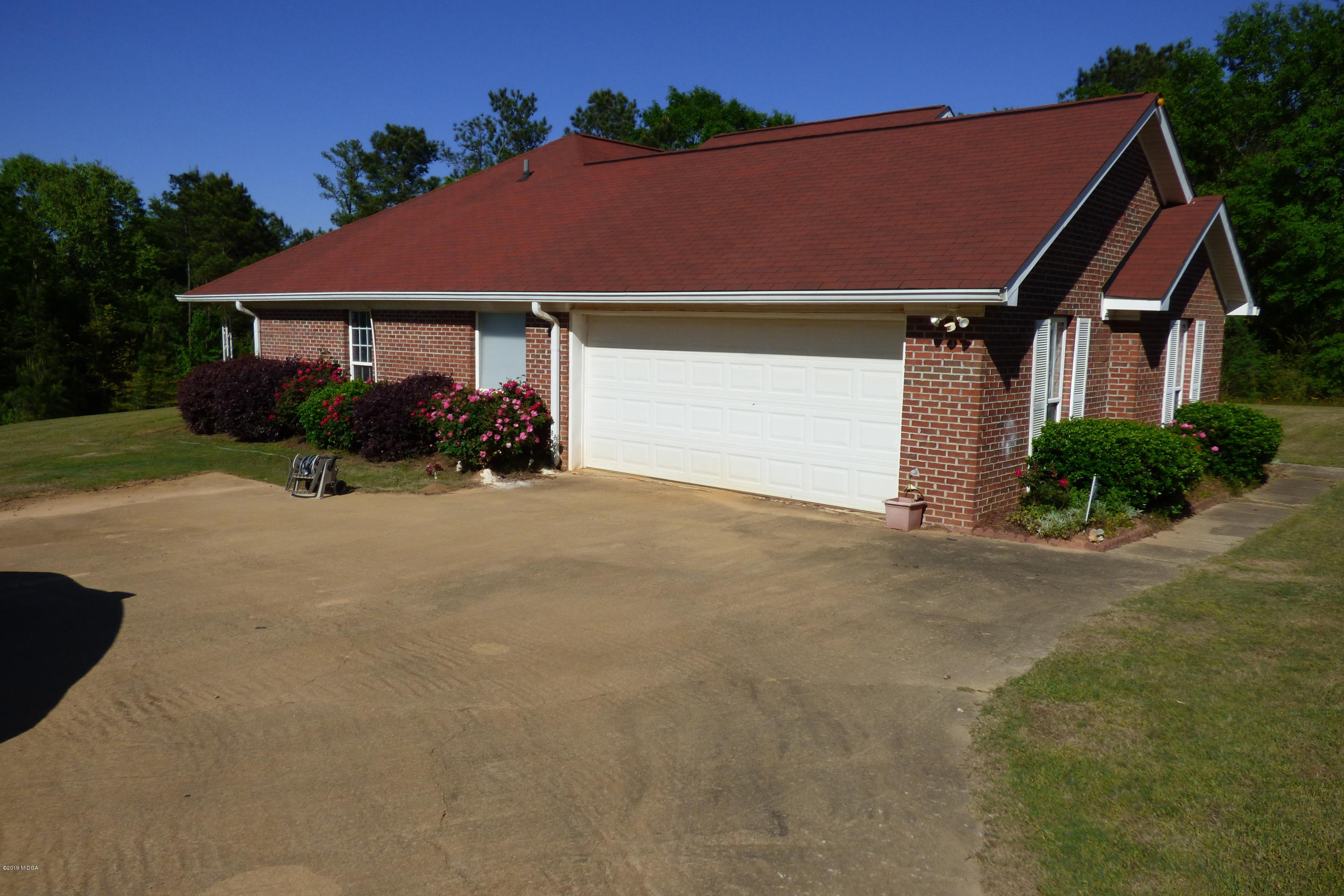 323 Rustin Road Reynolds, GA 31076 - Photo 3 of 25 a view of a house with a yard and potted plants