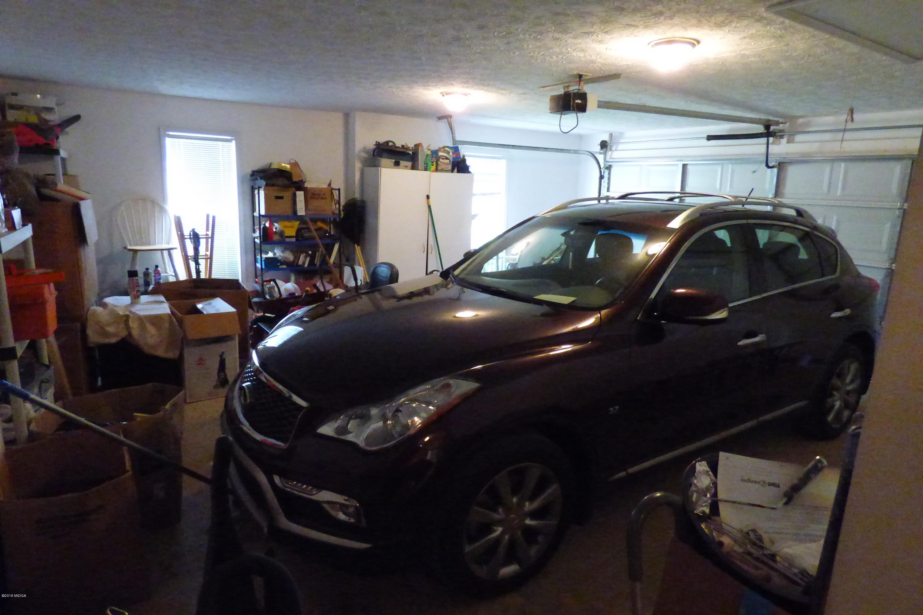 323 Rustin Road Reynolds, GA 31076 - Photo 25 of 25 a view of a garage with cars