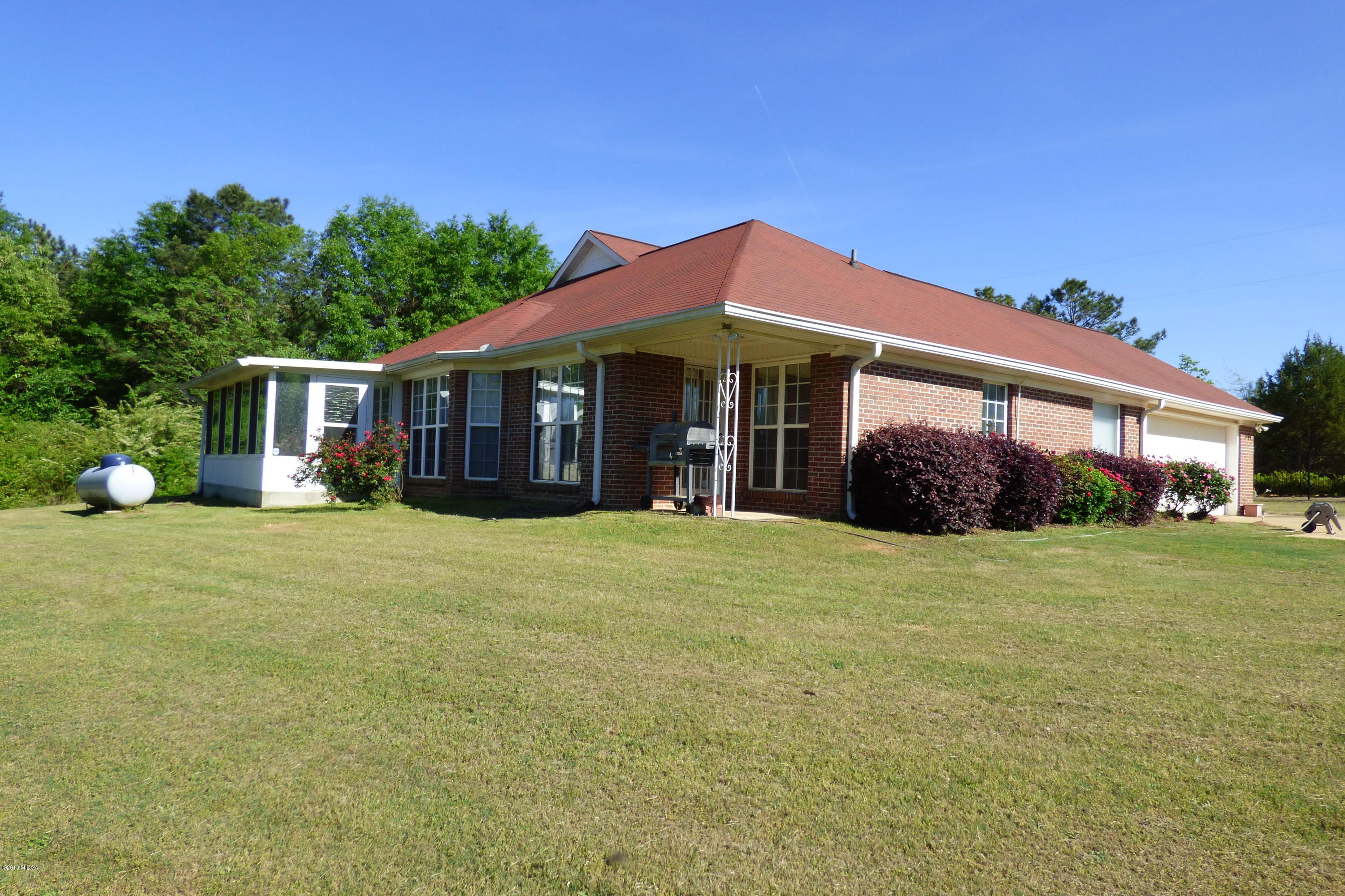 323 Rustin Road Reynolds, GA 31076 - Photo 4 of 25 a front view of a house with a garden
