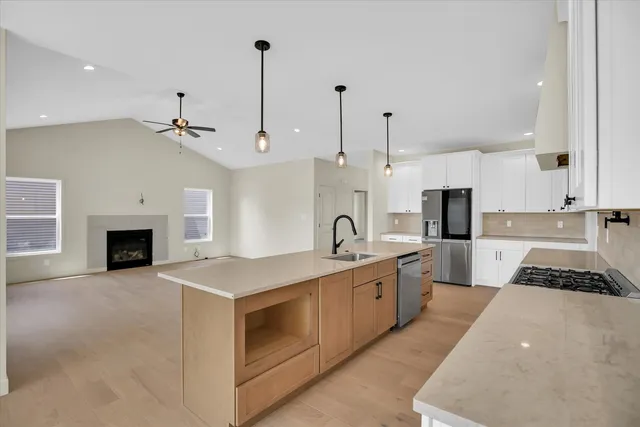 a kitchen with stainless steel appliances a sink stove and cabinets