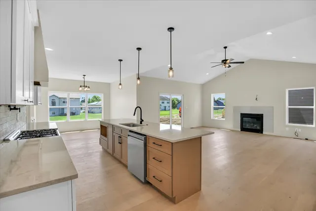 a kitchen with stainless steel appliances a refrigerator and cabinets