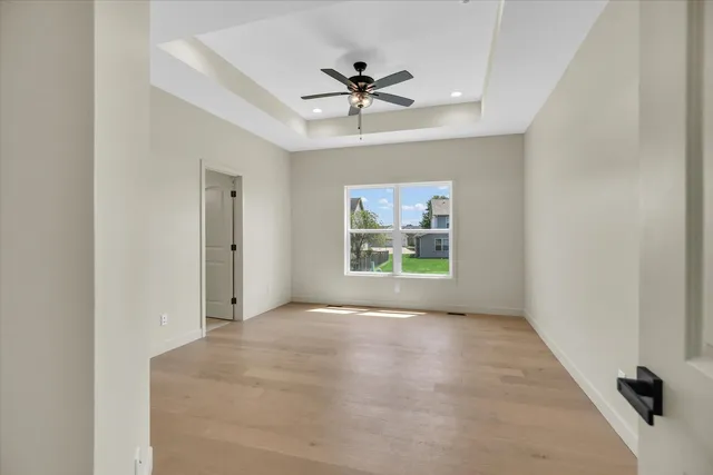 a view of empty room with ceiling fan